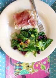 Listový salát s restovanou paprikou a olivami a bagetka s prosciuttem